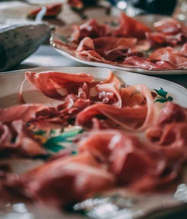 Sliced cured meats laid out on a cold display platter